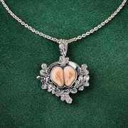 Hunting necklace made from a  pair of hind grandles, on a green background