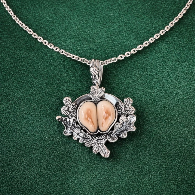 Hunting necklace made from a  pair of hind grandles, on a green background