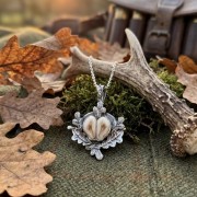 Silver necklace with grandles against an antler background